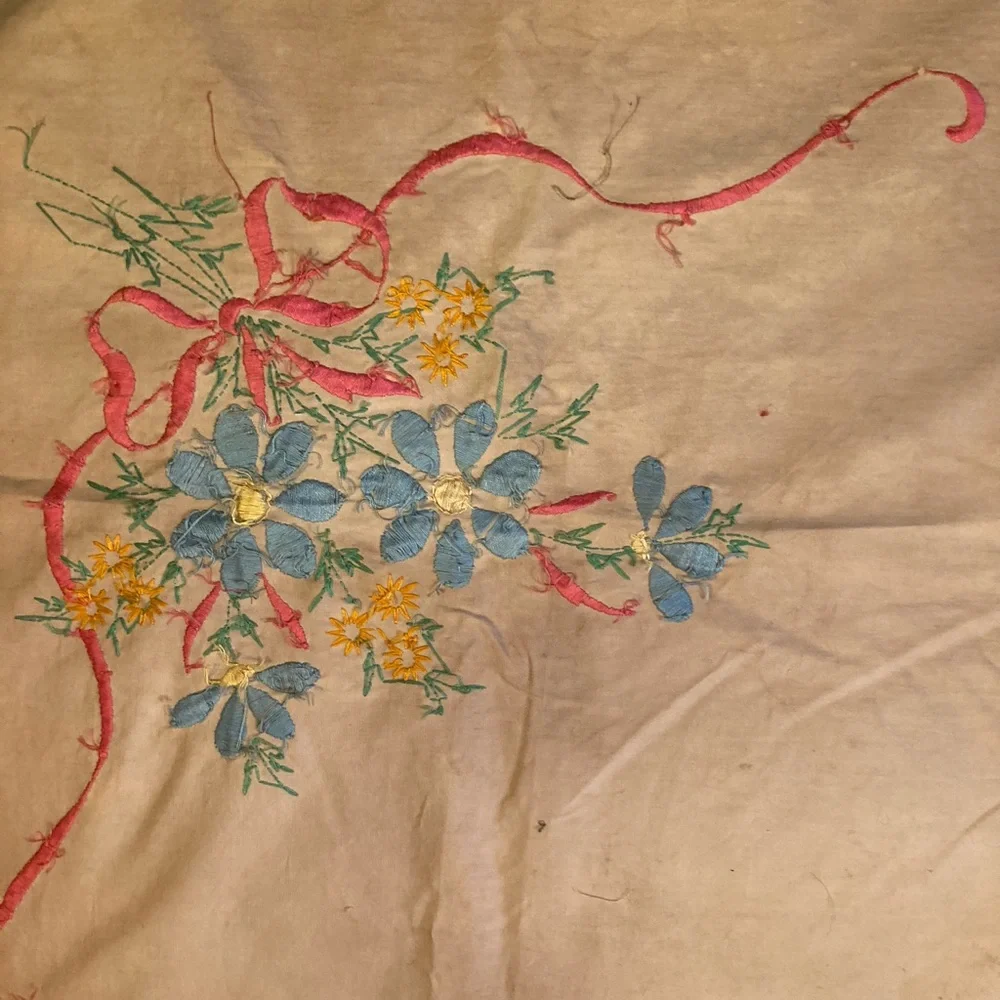 Vintage embroidery muslin, three corners begun, one ink outline blue pink red